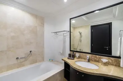 a bathroom with a tub and a sink and a mirror at The Smart Concierge - Grandeur Residence - Maurya in Dubai