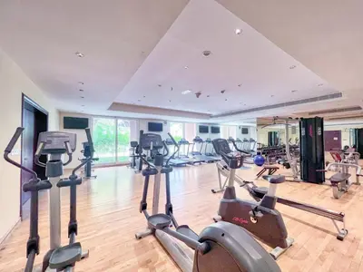 a gym with treadmills and elliptical machines at The Smart Concierge - Grandeur Residence - Maurya in Dubai