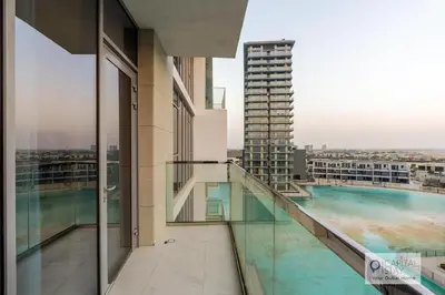 a balcony of a building with a swimming pool at 2 Bed Apt in District One Dubai - Lagoon Views in Dubai