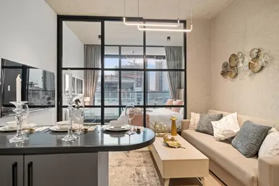 a living room with a table and a couch at luxury london style studio-loci residences in Dubai
