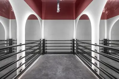 an empty arena with black boxing racks at luxury london style studio-loci residences in Dubai