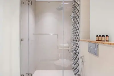 a shower with a glass door in a bathroom at Silkhaus in Collective Tower Luxorious 2BDR in Dubai