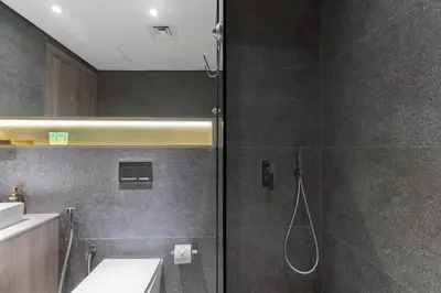 a bathroom with a shower and a toilet and a sink at Waves - Luxurious Comfort with City Views in Oxford 212 in Dubai
