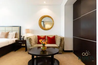 a room with a couch and a table with a mirror at The Haven in Dubai