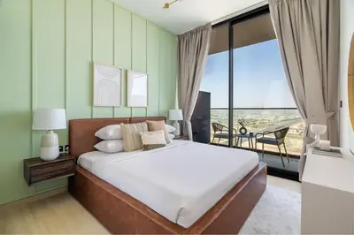 a bedroom with a large bed and a balcony at GuestReady - Glamorous stay at Binghatti Corner in Dubai