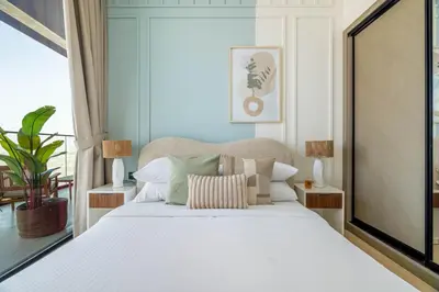 a bedroom with a bed with white sheets and pillows at GuestReady - Glamorous stay at Binghatti Corner in Dubai