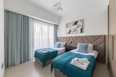a hotel room with two beds and a window at Spacious 3BR plus maids Burj Khalifa View in Dubai
