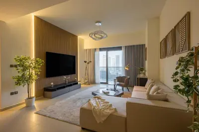 a living room with a couch and a flat screen tv at Spacious 3BR plus maids Burj Khalifa View in Dubai
