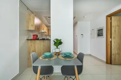a dining room with a blue table and chairs at ShoresInn - Waterfront in Heart of Dubai Marina in Dubai