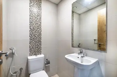 a bathroom with a toilet and a sink at ShoresInn - Waterfront in Heart of Dubai Marina in Dubai
