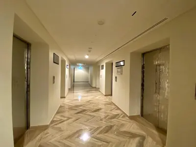 a hallway of an office building with a wooden floor at NiceVisit Merano 1BD Business Bay in Dubai