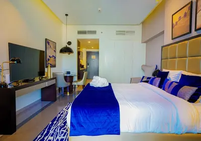 a hotel room with a large bed and a bathroom at NiceVisit Majestine Stuido Business bay in Dubai