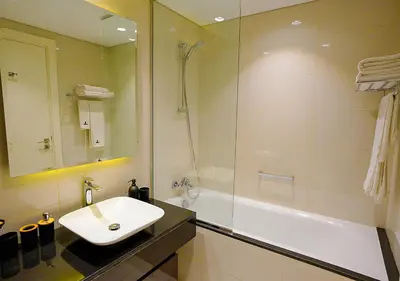 a bathroom with a sink and a shower and a tub at NiceVisit Majestine Stuido Business bay in Dubai