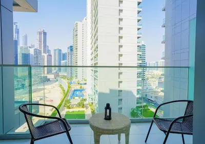 a balcony with a table and chairs and a view of a city at NiceVisit Majestine Stuido Business bay in Dubai