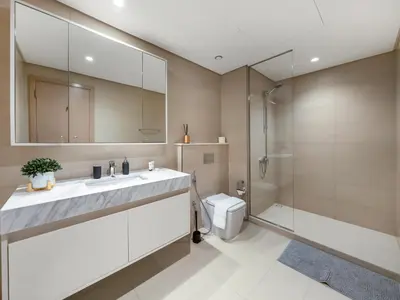 a bathroom with a sink and a shower and a toilet at Burj Khalifa View Luxe 2BR, 5 Mins walk to Dubai Mall in Dubai