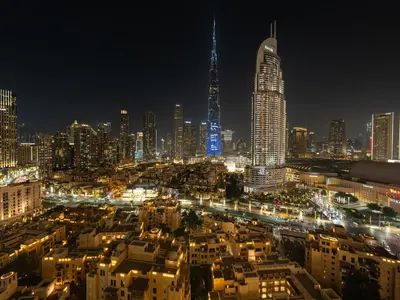 a view of a city at night with lights at Burj Khalifa View Luxe 2BR, 5 Mins walk to Dubai Mall in Dubai