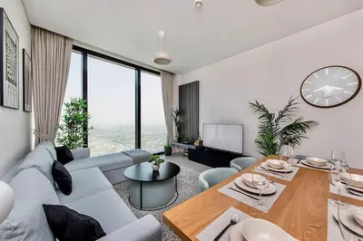 a living room with a couch and a table at Famous Address JBR HIGH FLOOR Sea View in Dubai