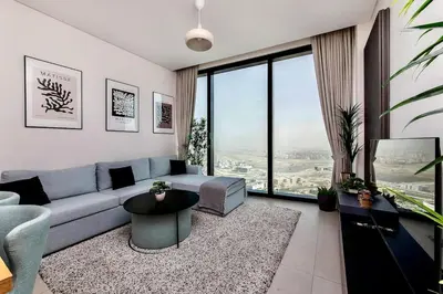 a living room with a couch and a large window at Famous Address JBR HIGH FLOOR Sea View in Dubai