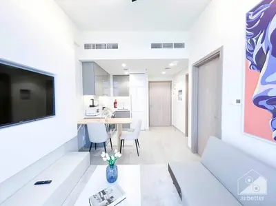 a living room with a couch and a table at Elegant 1BR with Balcony in Azizi Riviera in Dubai