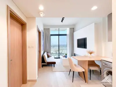 a kitchen and dining room with a table and chairs at Elegant 1BR with Balcony in Azizi Riviera in Dubai