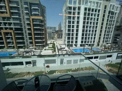 a large white train on a track in a city at Stunning Studio in Meydan Azizi 42 in Dubai