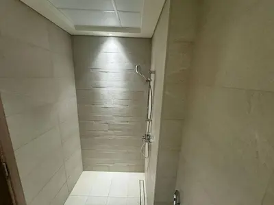 a bathroom with a shower with a glass door at Stunning Studio in Meydan Azizi 42 in Dubai