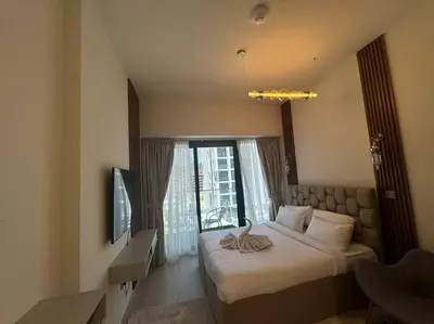 a hotel room with a bed and a window at Stunning Studio in Meydan Azizi 42 in Dubai