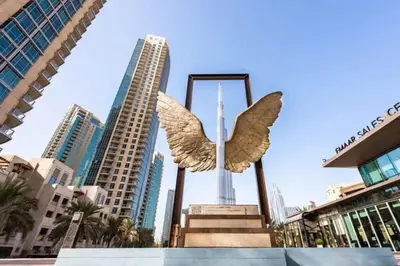 a statue of an angel in the middle of a city at Downtown Gem, Fountain View! in Dubai