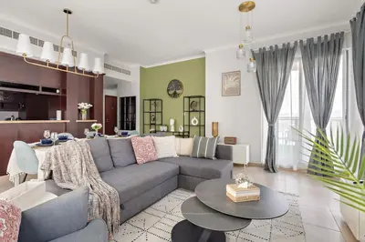 a living room with a couch and a table at Downtown Gem, Fountain View! in Dubai