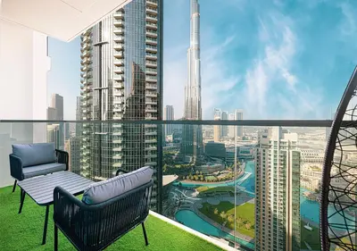a balcony with a chair and a view of a city at Luxury Apartment with Full Burj Khalifa and Downtown Views in Dubai