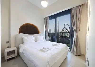 a bedroom with a bed and a large window at Luxury Apartment with Full Burj Khalifa and Downtown Views in Dubai