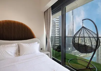 a bedroom with a bed and a large window at Luxury Apartment with Full Burj Khalifa and Downtown Views in Dubai