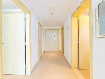 an empty hallway with white walls and white doors at Seaside Elegance-1BR-Al Bateen-Private Beach Access in Dubai