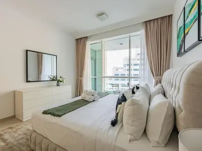 a bedroom with a large bed and a large window at Seaside Elegance-1BR-Al Bateen-Private Beach Access in Dubai