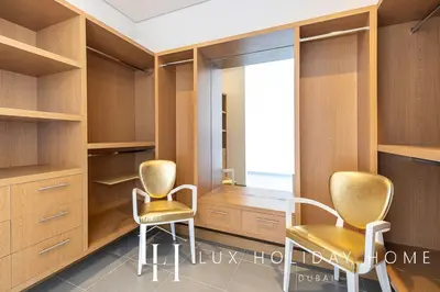 two chairs in a dressing room with a window at LUX The Dream Palm Atlantis Sea View Suite in Dubai