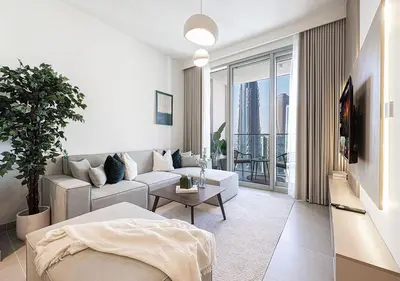 a living room with a couch and a table at Kinfolk Homes - 5-Star Family Stay, 8 Minutes Walk to Dubai Mall & Burj Khalifa in Dubai