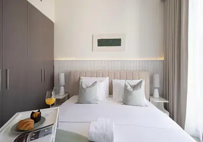 a bedroom with a bed with a plate of food on it at Kinfolk Homes - 5-Star Family Stay, 8 Minutes Walk to Dubai Mall & Burj Khalifa in Dubai