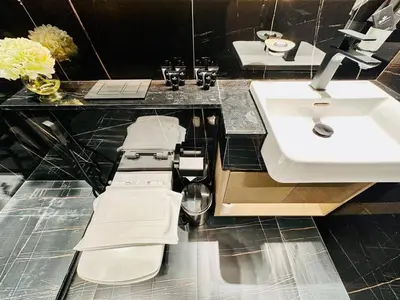 a bathroom with a sink and a toilet and a counter at Modern 1br In Jvc Fully Furnished & Balcony in Dubai