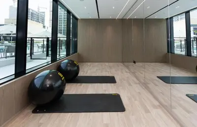 a yoga room with black mats and large windows at Modern 1br In Jvc Fully Furnished & Balcony in Dubai