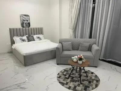 a living room with a couch and a coffee table at Luxury & Comfort in Majan A Dubai Delight in Dubai