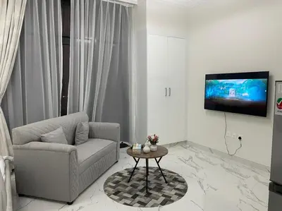 a living room with a couch and a table at Luxury & Comfort in Majan A Dubai Delight in Dubai