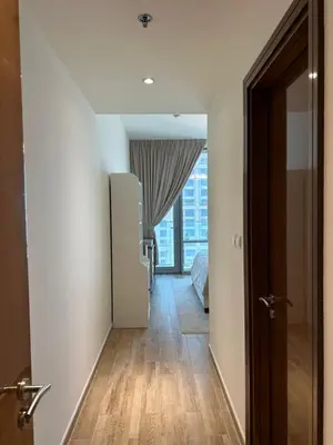 a hallway with a refrigerator and a room with a window at 2 Bedroom in Noora Tower, Fully furnished, Sea View in Dubai