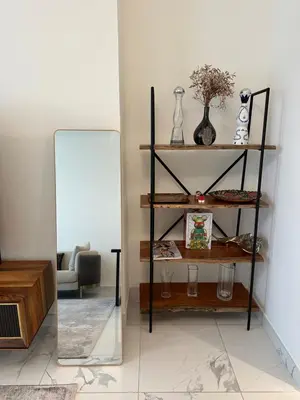 a mirror in a room with a chair and a couch at 2 Bedroom in Noora Tower, Fully furnished, Sea View in Dubai
