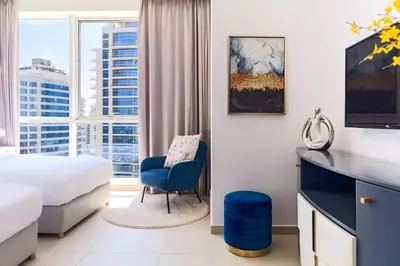 a hotel room with a bed and a desk and a chair at Luxury stay Private Beach Access in Dubai