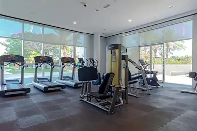 a gym with a bunch of treadmills and machines at Luxury stay Private Beach Access in Dubai