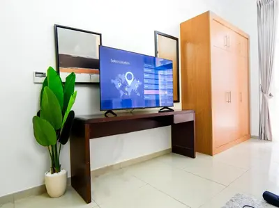 a flat screen tv sitting on a desk in a room at EasyGo -Stylish STU With pool view Linkin park Arjan- 17 in Dubai
