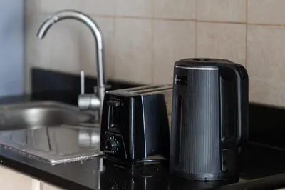 a toaster sitting on a kitchen counter next to a sink at Sunny Studio Perfect For Discovery Gardens Stays in Dubai