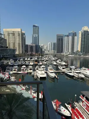 a bunch of boats docked in a harbor in a city at Luxurious Waterfront at Al Majara Dubai Marina in Dubai