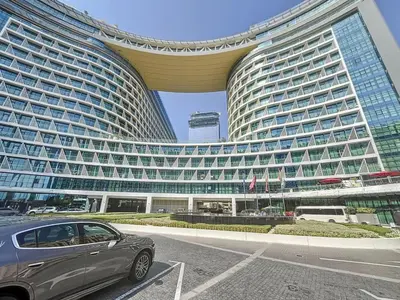 a car parked in front of a large building at Seven Hotel and Apartment - Chic Studio in the Palm in Dubai