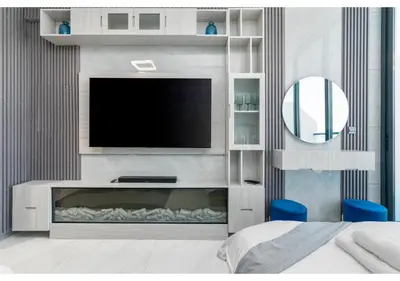 a living room with a tv and a fireplace at Bright Resort Style Studio Amenities Samana GA by Vibel in Dubai